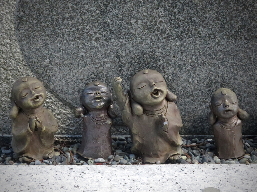 Small joyful Jizo figures in Koya-san graveyard