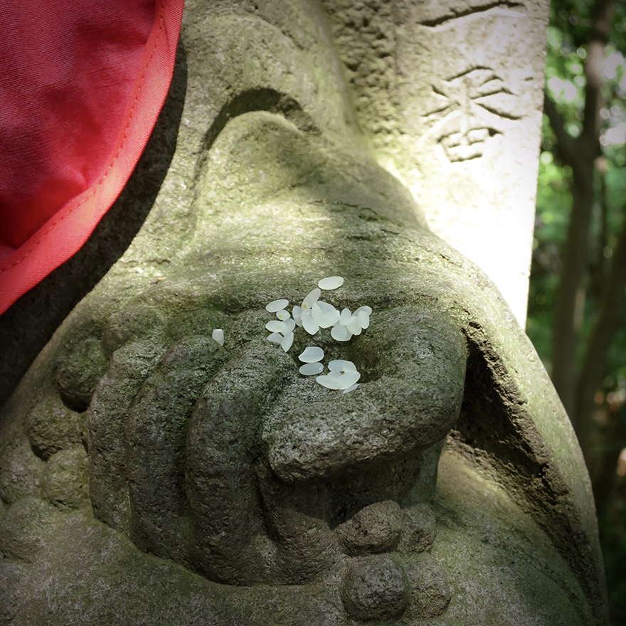 Rice offering left by pilgrim at Jizo figure on pilgrimage hike at Takahata Fudo-san