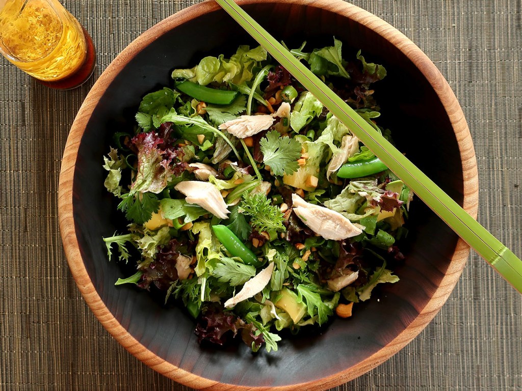 Photo of salad with chicken, avocado, cashews, cilantro, snap peas, green onions and soy lemon dressing
