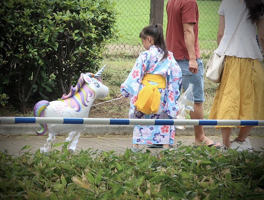 Small girl in yukata with unicorn balloon at the Edogawa Goldfish Festival