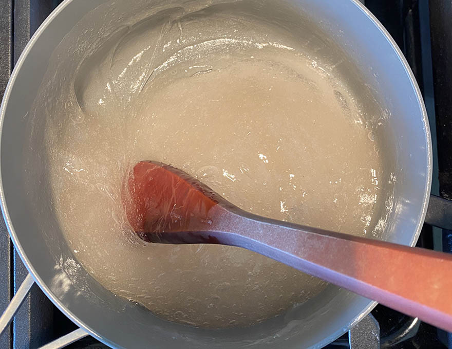 Warabi mochi cooking in saucepan on top of the stove