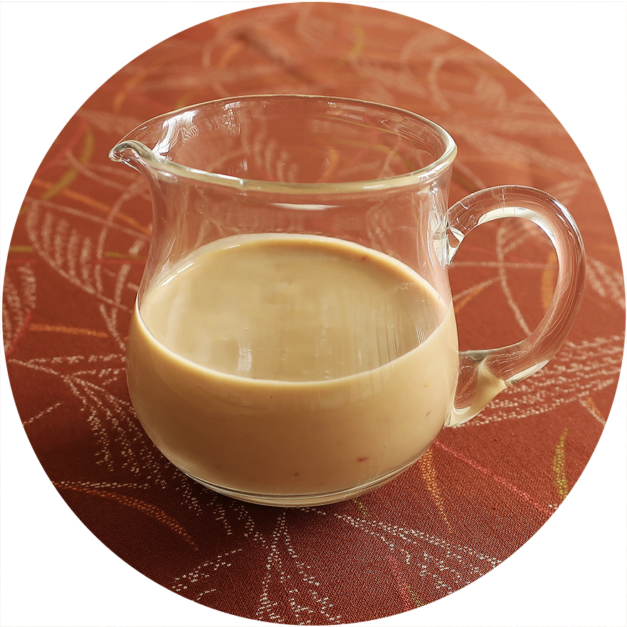 Clear pitcher of spicy miso dressing