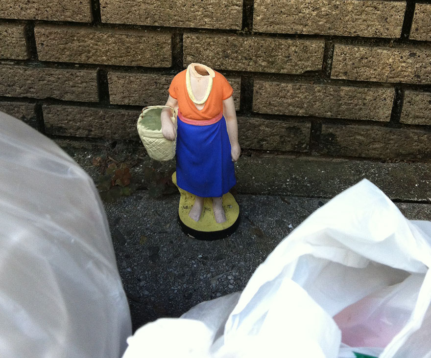 Headless plastic character figure awaiting trash collection in Tokyo