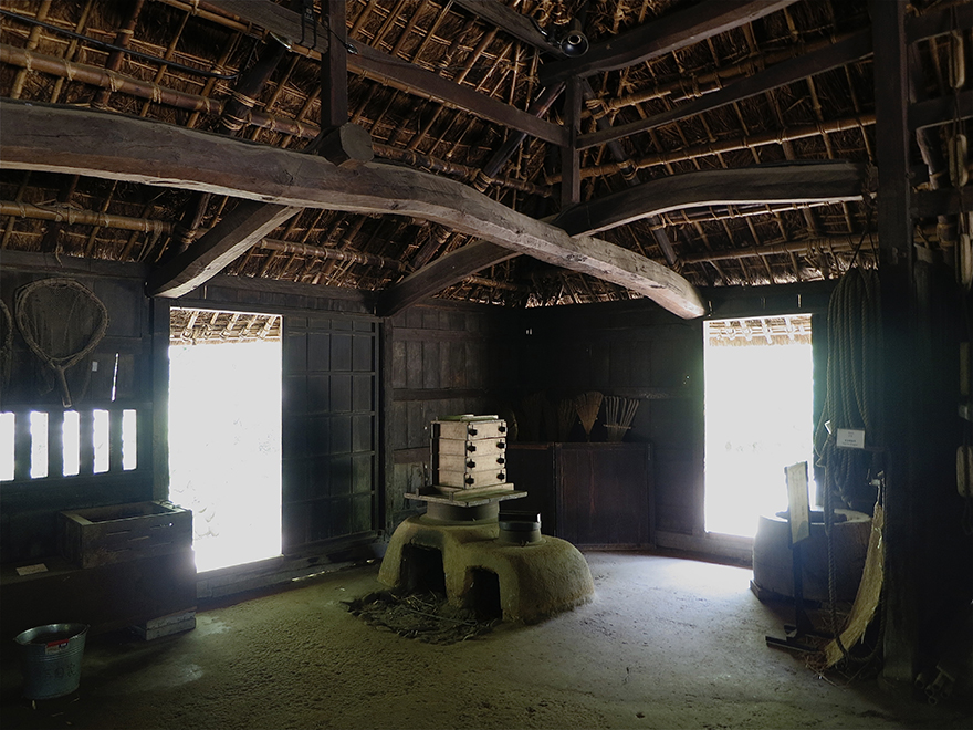 Kitchen interior of a thatch-roofed farmhouse at the Nihon Minka-en Japanese Folk House Garden
