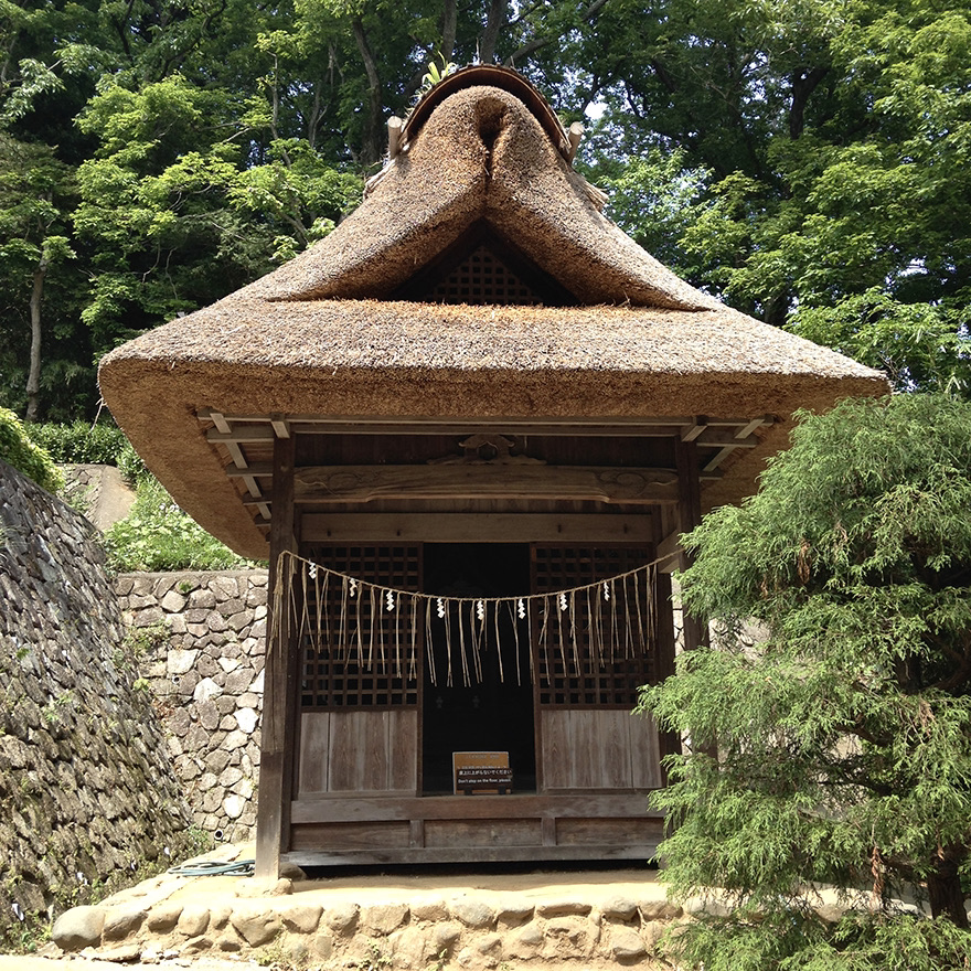 Thatch-roofed shrine at the Nihon Minka-en Japanese Folk House Garden