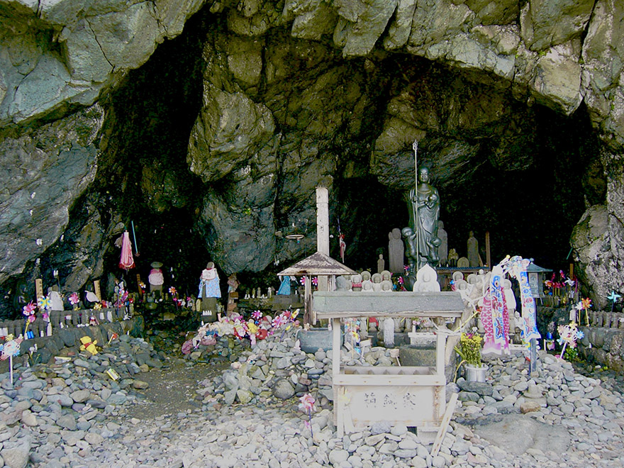 Jizo statues offered in a cave memorial for lost children on Sado Island