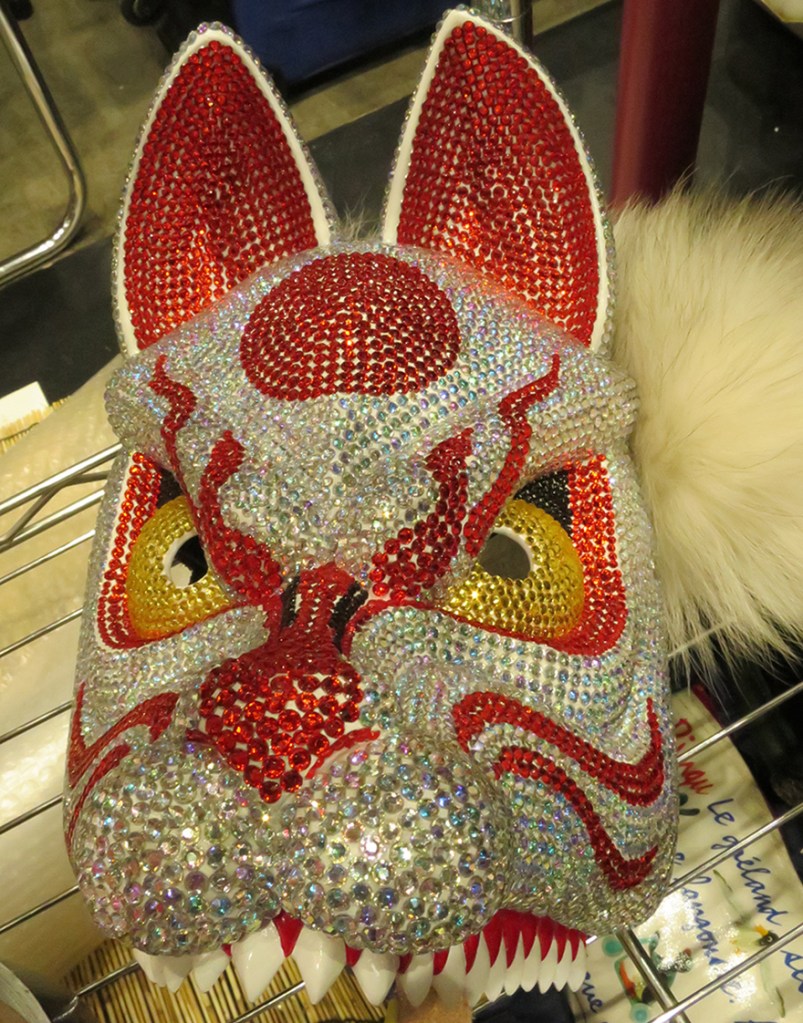 Fax mask covered with rhinestones at Design Festa