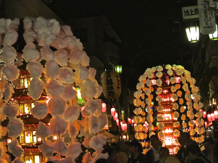Photo of pagodas parading down the street at night at the oeshiki ikegami festival in Tokyo