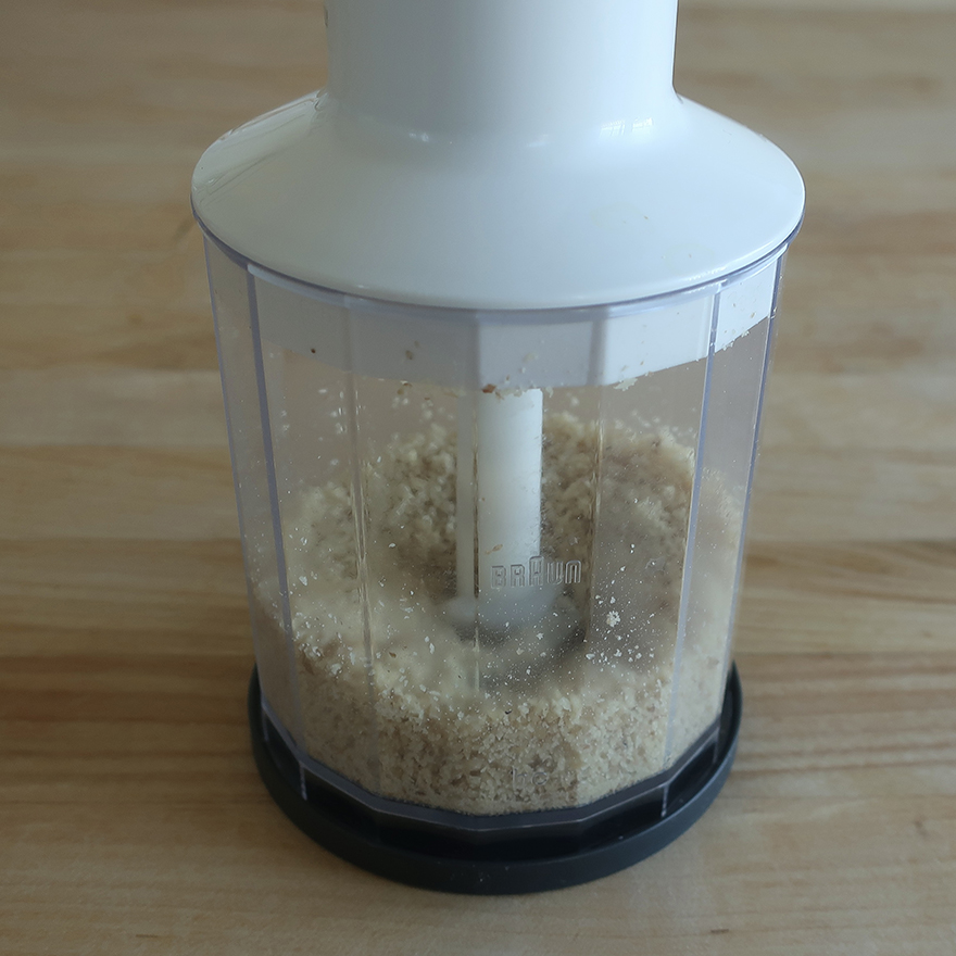 Photo of ground walnuts in food processor